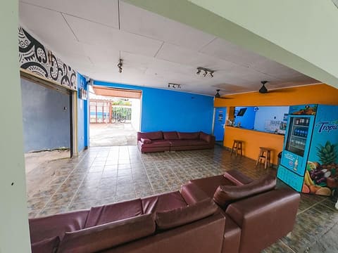 The lounge: maroon leather sofas, blue and orange walls, a drinks machine and the front counter.